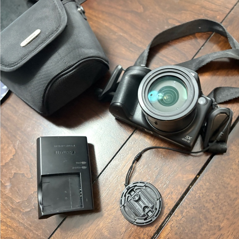 Canon Black Digital Camera with Lens Cap and Charger